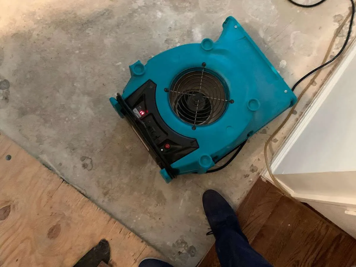 Air mover drying subfloor during Leak Detection & Repair in Swanzey